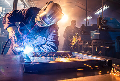 The,Two,Handymen,Performing,Welding,And,Grinding,At,Their,Workplace