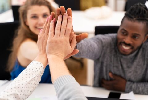 close-up-colleagues-high-five_23-2149008902