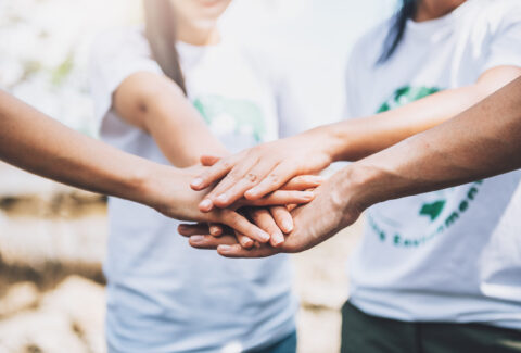 close-up-people-volunteer-teamwork-putting-finger-star-shapehands-togetherstack-handsunity-teamwork-world-environment-day